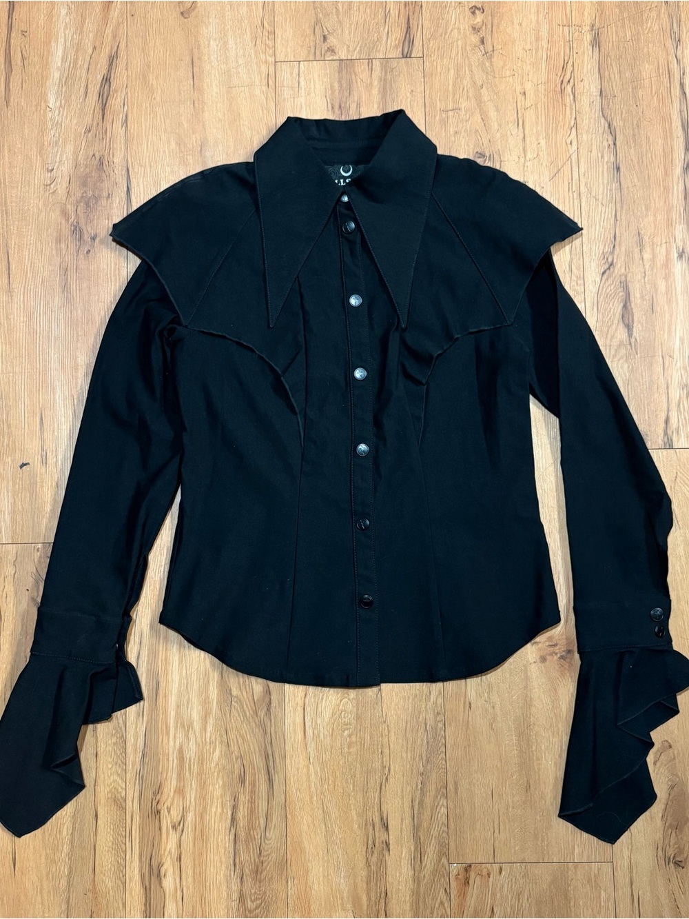Black button down shirt with ruffled cuffs and collar